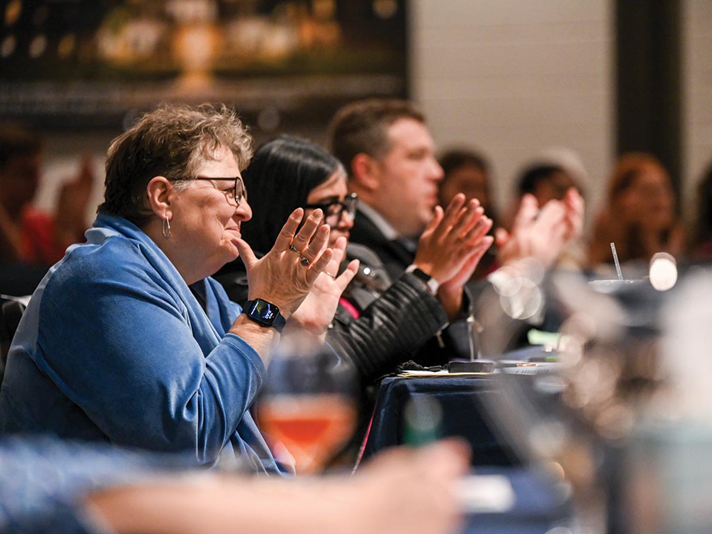 Donna Weimer and judges, from the left, Parisha Shah ’01, Jeffrey Bellomo ’00, and Suzy Atkins ’93 (hidden), applauded the seven finalists.